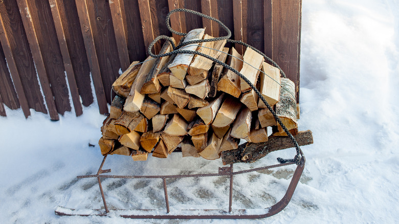 firewood stacked on vintage sled