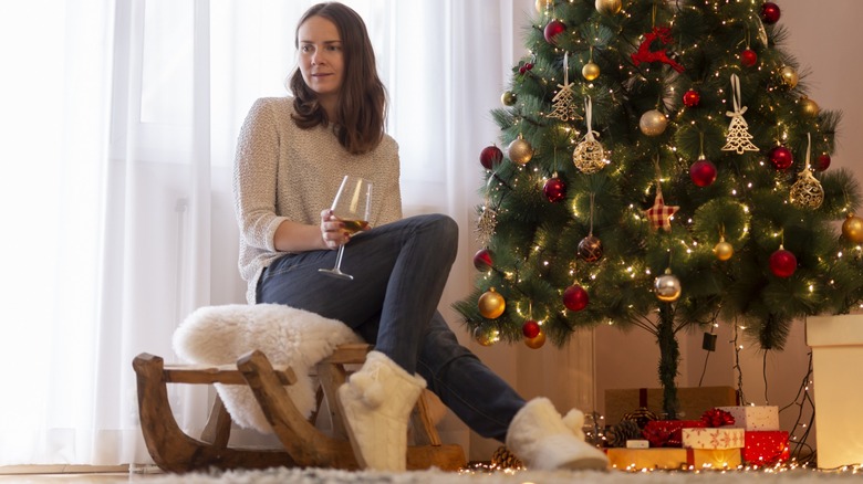 woman sitting on sled inside home