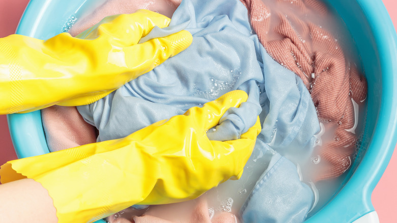 Handwashing clothes with gloves