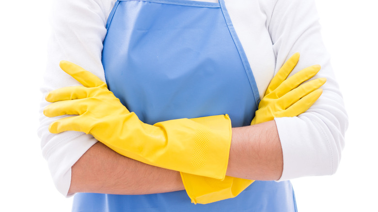 Woman wearing housekeeping gloves