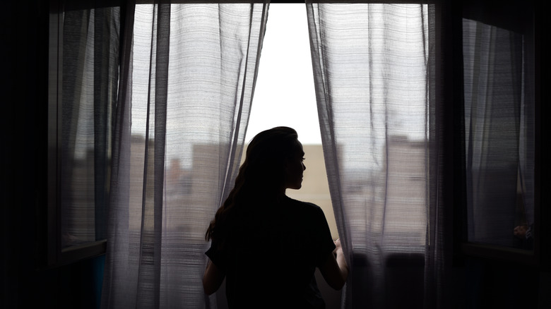 Woman looking out of a window 