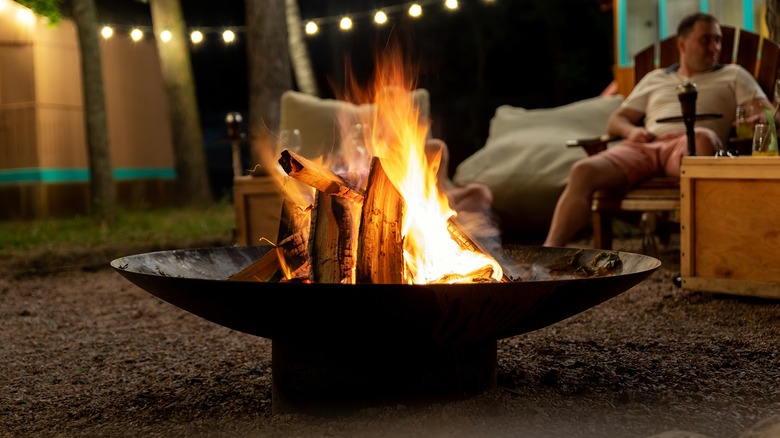 bonfire surrounded by chairs