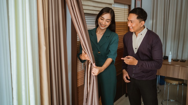 Couple looking at curtains