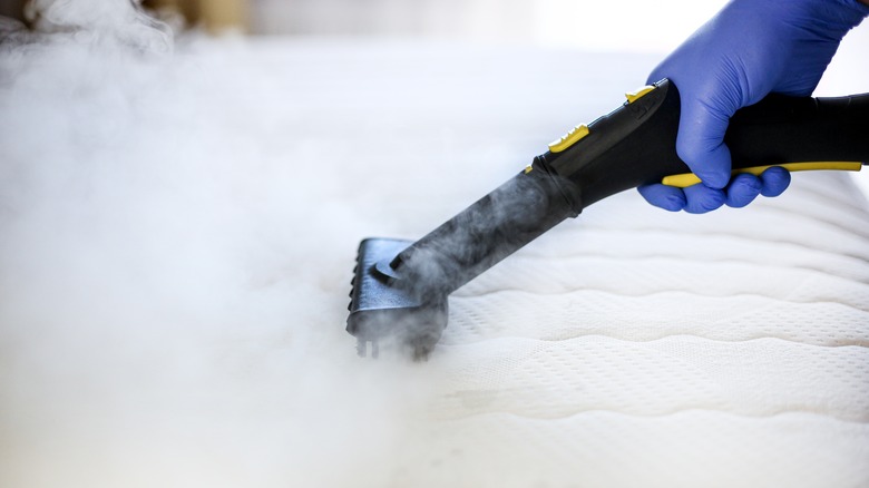 person steaming mattress