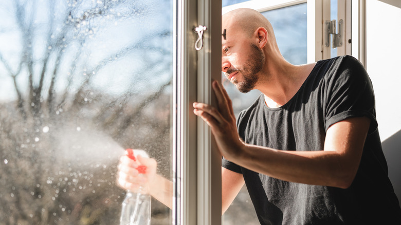 Man spraying window