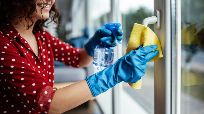 Woman wearing gloves while cleaning