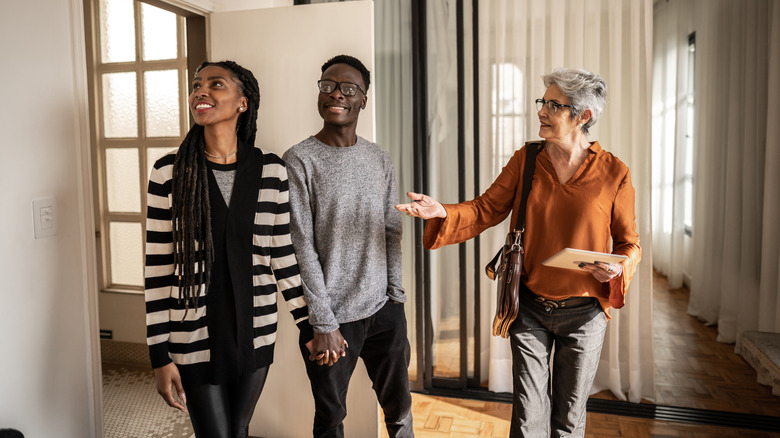 agent showing home to couple