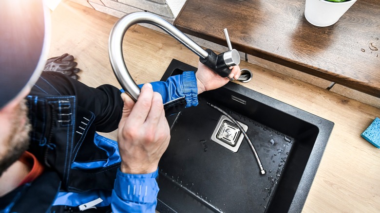 plumber working on kitchen sink