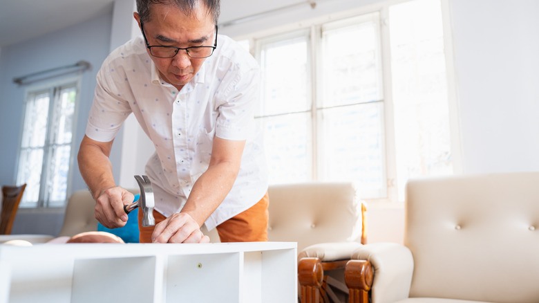 A man working on a project with a hammer