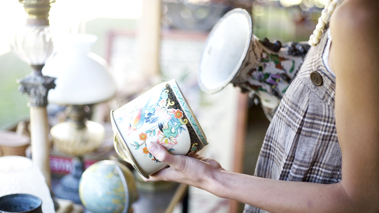 Woman holding antique vase