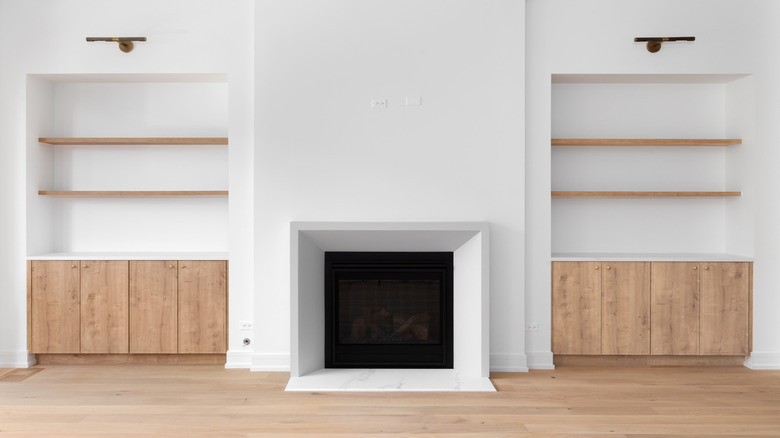 Floor mounted cabinets around fireplace