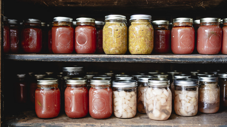 filled mason jars on two shelves