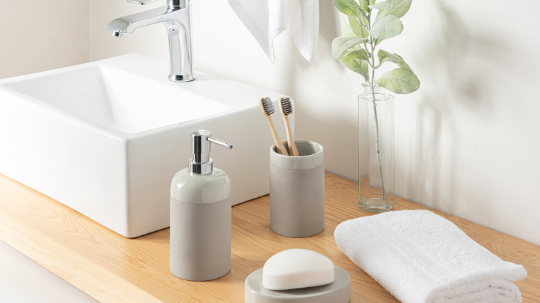 The bathroom sink as many items scattered next to it.