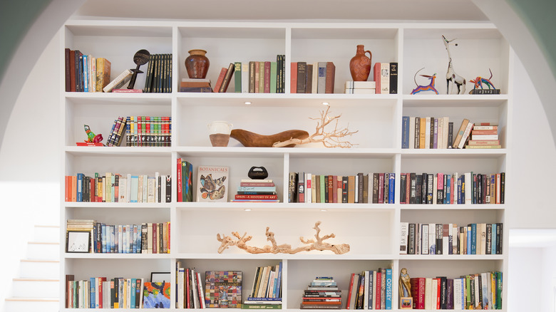 bookshelf with neatly organized board games in book boxes