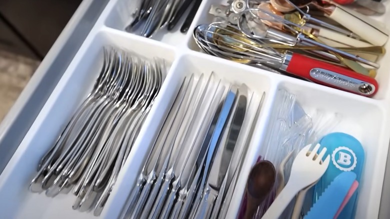 Flatware stacked sideways in utensil organizer