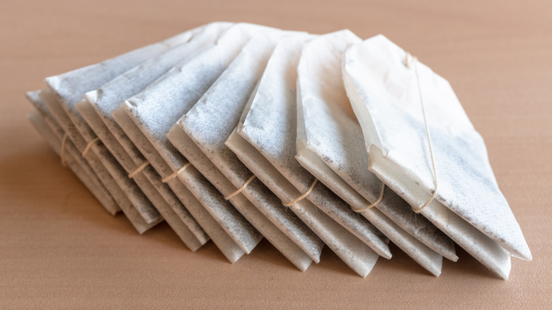 A stack of tea bags on a brown table