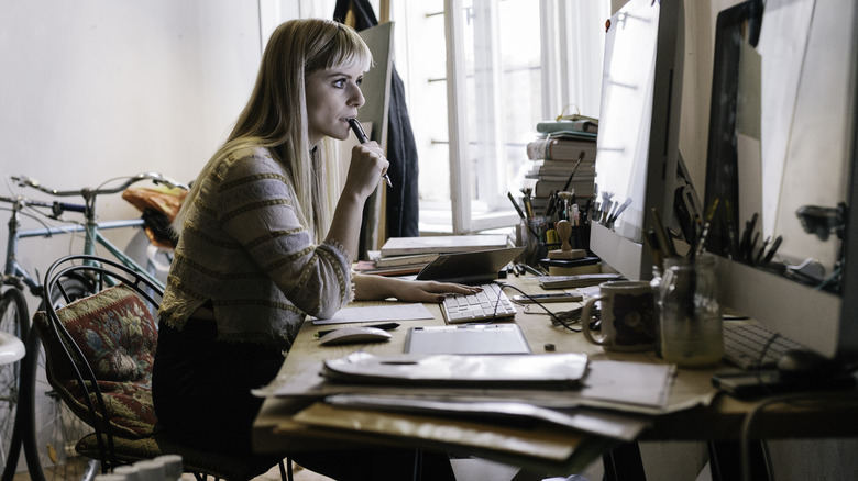 woman working at messy desk