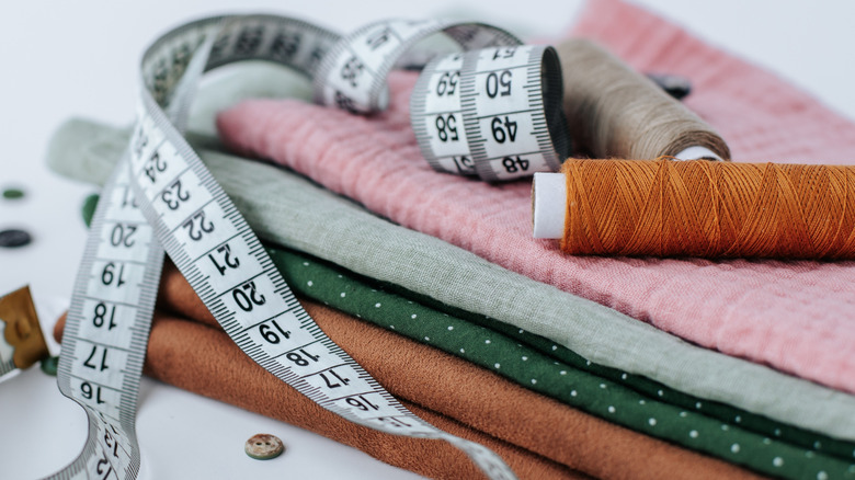 stack of different fabric scraps with measuring tape