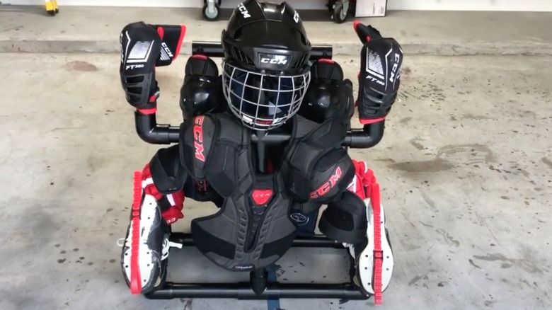 hockey equipment on PVC drying rack on concrete garage floor