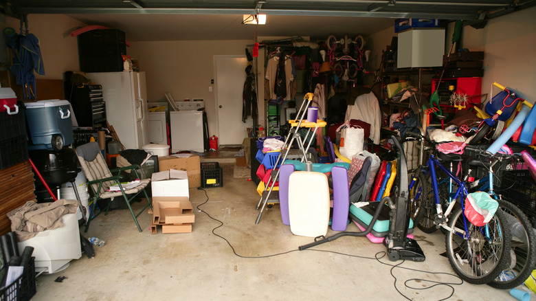 A messy garage filled with bikes and other items