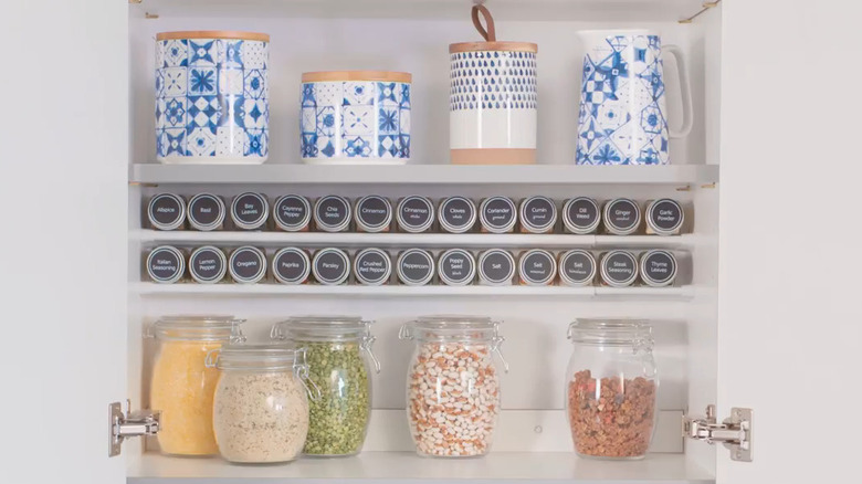 Spices on a tension rod shelf 