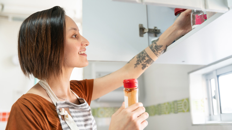 Woman sifts through spices 