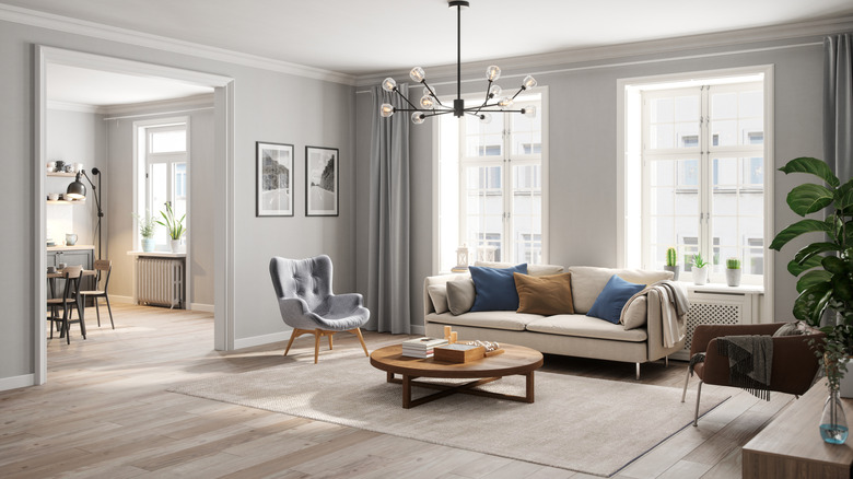 Decorated living room with long curtain rod and gray curtains