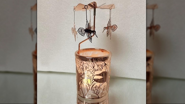 Rose gold rotating candle holder with hummingbirds