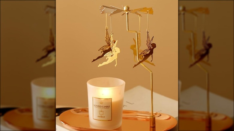 Gold rotating candle holder tray with flying fairies