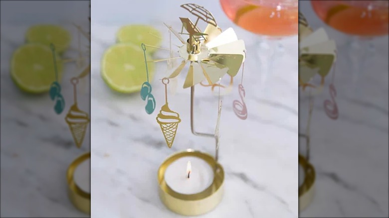 Beachy-themed gold rotating candle holder with flip flops and ice cream