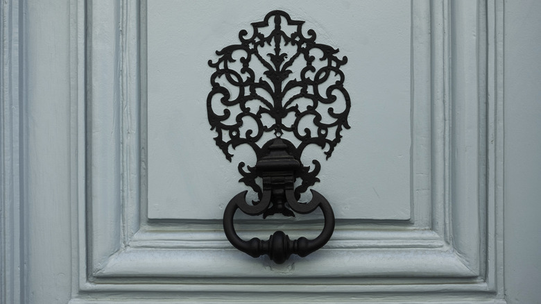 Ornate knocker on blue door