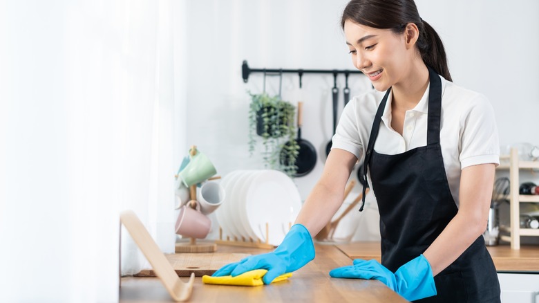 Woman cleaning kitchen counter