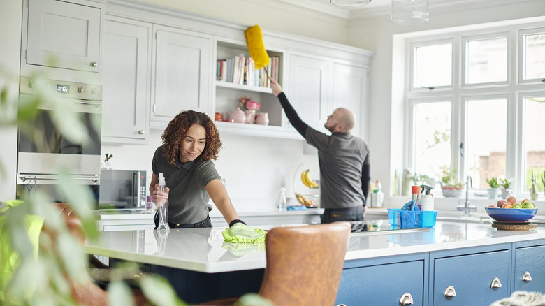 Couple cleaning kitchen