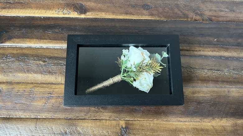 black shadow box with boutonniere