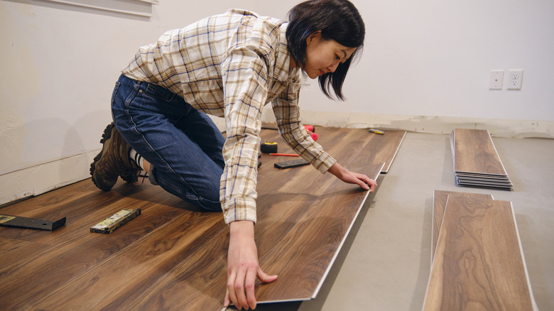 woman installing flooring