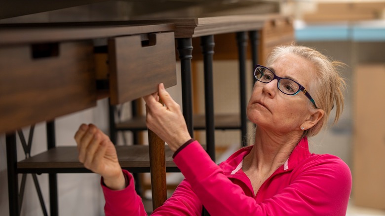 Woman testing a vanity's drawers