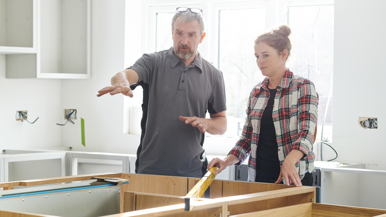 Man and woman installing island