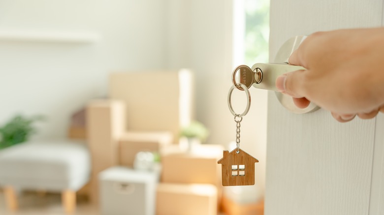 Person unlocking door to new home