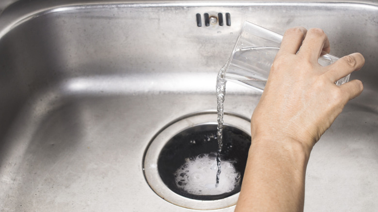 Pouring vinegar down garbage disposal