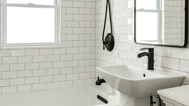 Matte black fixtures in white bathroom