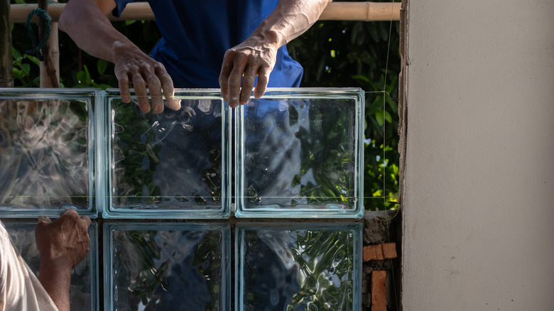 Masons setting a glass block wall