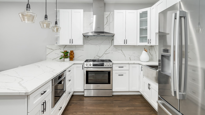 all white kitchen with white marble backsplash