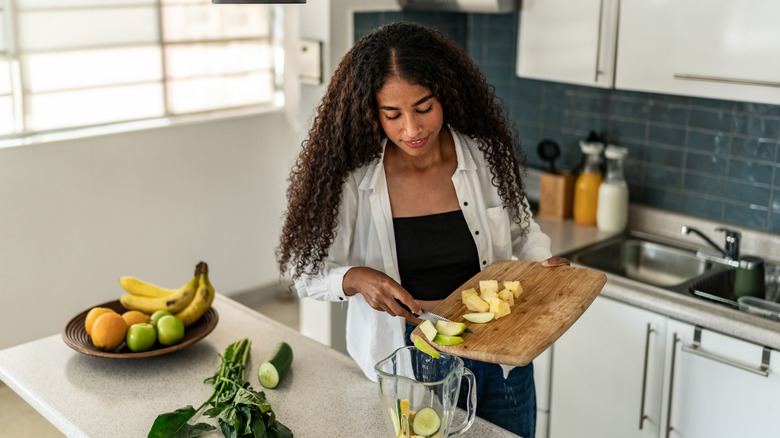 person cooking alone with small island