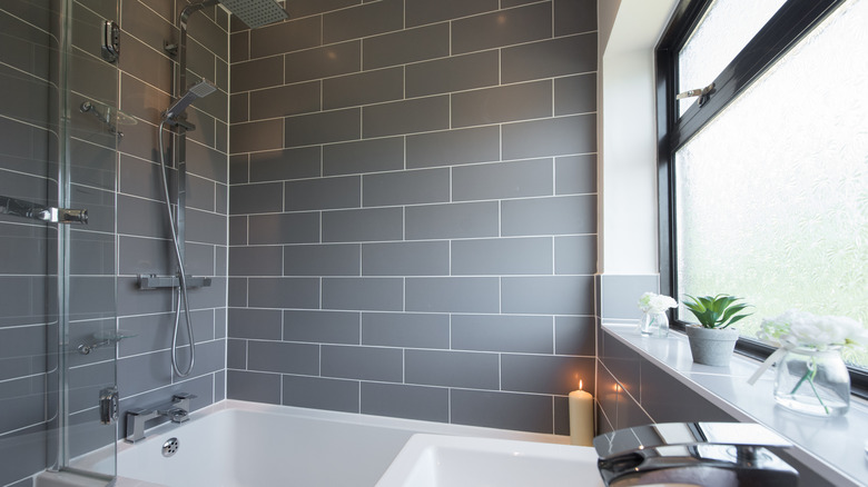 Gray tiled small bathroom with silver accessories