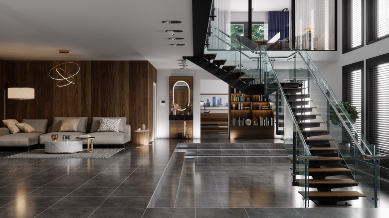 Living room of a luxurious home with stairs connecting the lower and upper levels