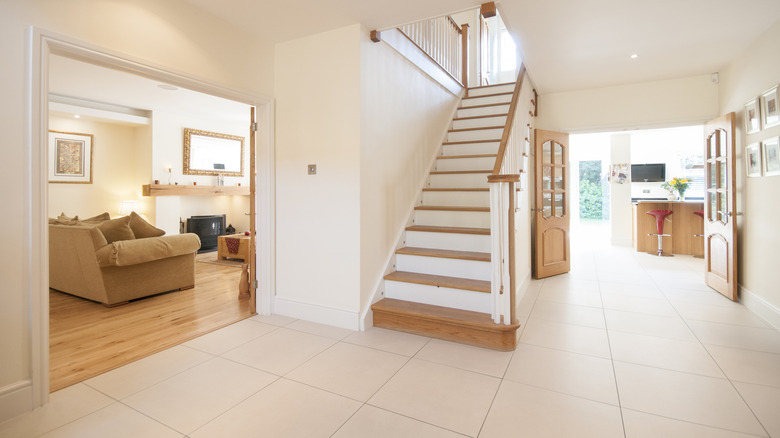 Partial view of a living room with stairs and kitchen to the side