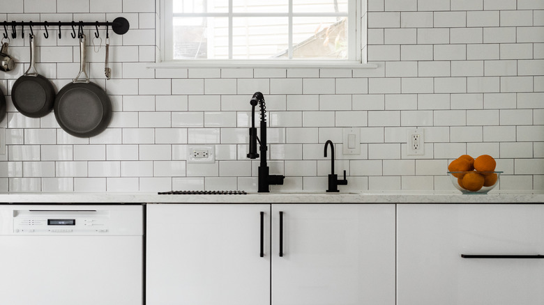 kitchen with white subway tile backsplash over sink