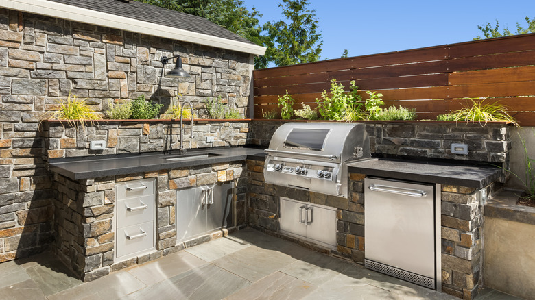 An outdoor kitchen with stone and granite materials.