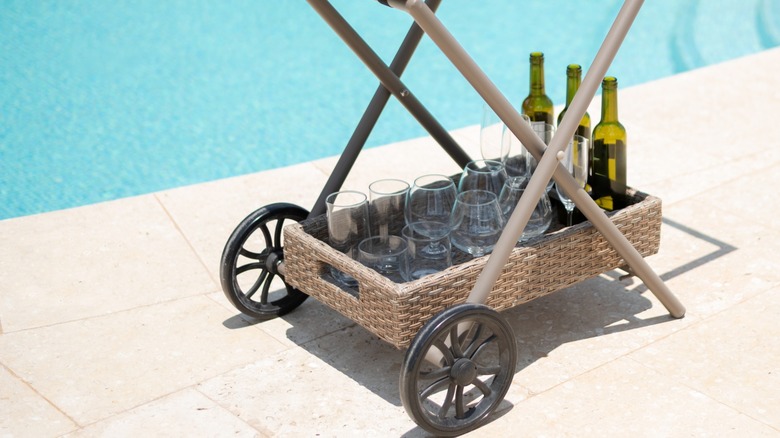 Rolling bar cart by pool