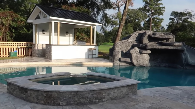 outdoor stone kitchen with barstools